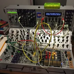 A three-row system filled with older Eurorack modules patched together for a sound design task